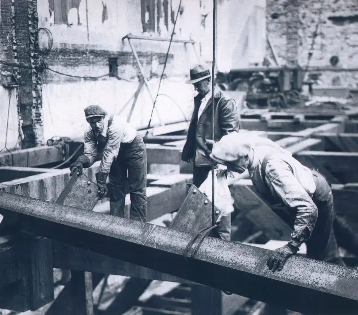 Black and white photo of steel workers in 1930