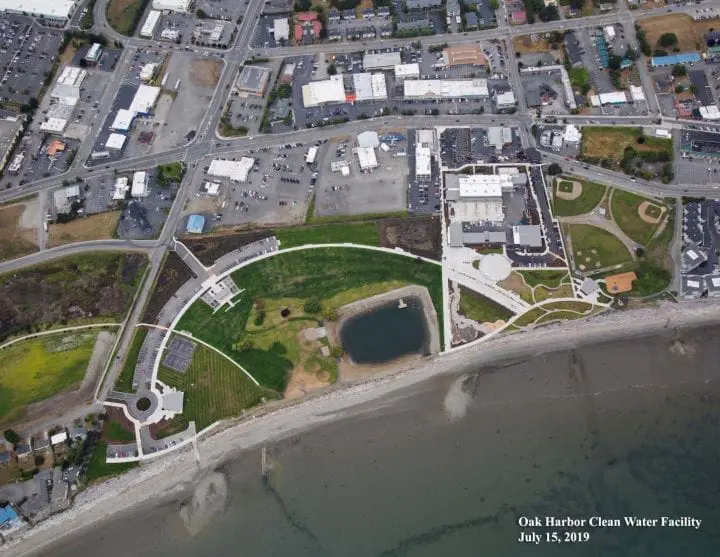 Aerial view of Oak Harbor Clean Water Facility; green spaces, water, and adjacent urban area, July 15, 2019.