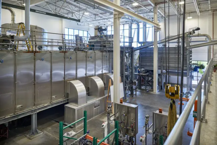 Industrial facility interior showcasing advanced machinery and equipment under a high ceiling.