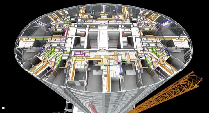 3D model of a circular building's internal structure with colorful network of pipes and systems, showcasing engineering design.